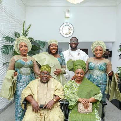 Tony Ojeshina with family members in matching traditional attire