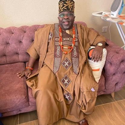 Tony Ojeshina seated in traditional Yoruba chieftaincy attire with coral beads